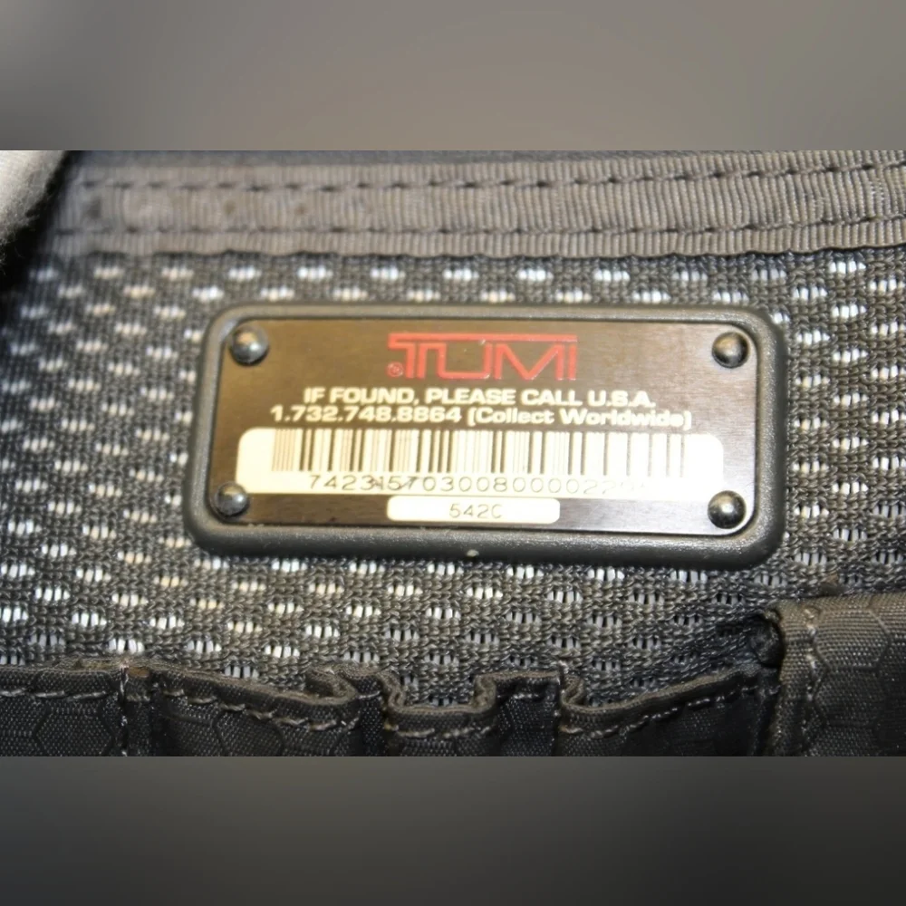 TUMI Black Backpack with Padded Straps and Multiple Compartments
